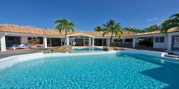 A luxurious 5 bedroom hillside villa with a magnificent pool area offering gorgeous views of the Caribbean Sea and Saba!