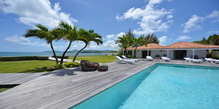 A quintessential 4 bedroom beachfront villa within a perfectly manicured garden oasis with swimming pool and stunning views of the Caribbean Sea!