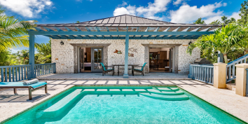 The pool deck of this Turks and Caicos villa rental also has a BBQ for your vacation pleasure.