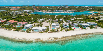 An aerial photograph of the Turtle Cove area of Grace Bay Beach with Coriander set one lot back.