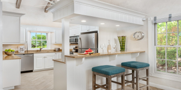 The open-concept living room and kitchen of Nutmeg Cottage offers everything you may need while on vacation in the Turks and Caicos Islands.