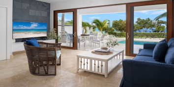 The comfortable and spacious beach level living room of Sea Edge Villa features a TV with web capabilities.