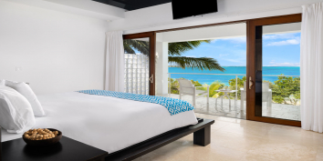 This Turks and Caicos luxury villa rental has gorgeous views of Grace Bay from the master bedroom suite.
