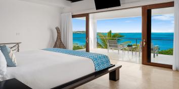 This Turks and Caicos luxury villa rental has a stunning master bedroom suite with fantastic views of the turquoise sea.