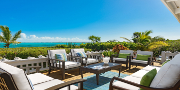 Enjoy Caribbean cocktails and the amazing views of Grace Bay Beach at this Turks and Caicos vacation villa rental.