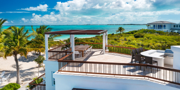 The rooftop deck is equipped with a full summer kitchen at Turtle Breeze Villa.