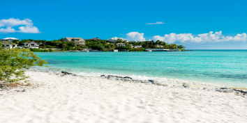 The soft, white sand of Taylor Bay Beach is only steps away from Coccoloba Beach House.