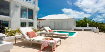 The pool terrace is perfect for soaking up the tropical sunshine while on vacation.
