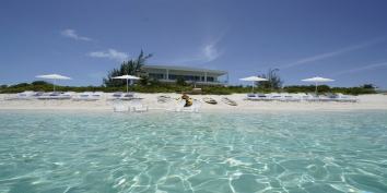 This Turks and Caicos luxury villa rental is only steps from the crystal clear sea in Grace Bay.