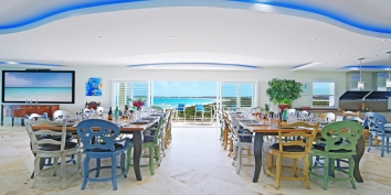 Two dining tables and spac for up to 24 guests at Impulse Beach Estate, Grace Bay Beach, Turks and Caicos Islands.