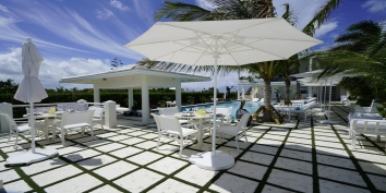 The spacious swimming pool terrace at Impulse Beach Estate, Grace Bay Beach, Turks and Caicos Islands.