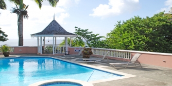 SOL Y MAR VILLA, TOBAGO W.I. A view from the patio: Imperial palms, the pool, gazebo, Caribbean sea, and coral reef.