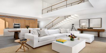 The open-concept living area of these Turks and Caicos luxury villa rentals have double-height ceilings.