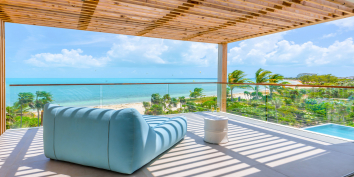 The grand master suite of Beach Enclave Long Bay Villa 2 has a private terrace with magnificent views.