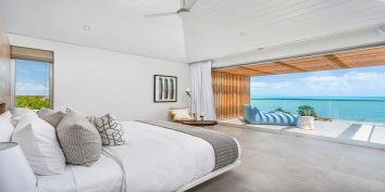 The grand master suite is the only room on the upper level of this Turks and Caicos luxury villa rental.