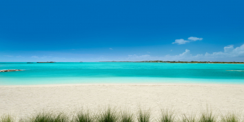 The private beach and turquoise sea at villa Emerald Bay, Providenciales, Turks and Caicos Islands.