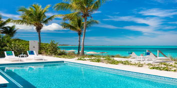 The heated, beachfront swimming pool with outdoor shower at Grace Too, Grace Bay Beach, Providenciales (Provo), Turks and Caicos Islands.